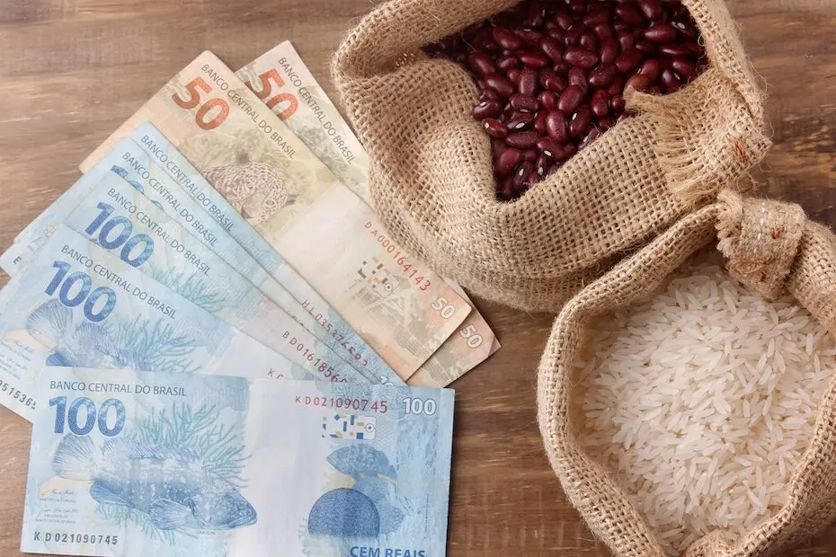 Rio de Janeiro, Brazil - September 7, 2020: basic food from brazil, rice and beans, next to a hundred reais bill, currency of brazil